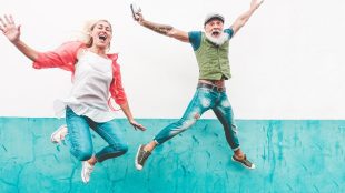 Mature trendy people jumping about and having fun dancing and celebrating outside - Joyful mature lifestyle concept. Are you ready for a serious relationship - Silver Magazine www.silvermagazine.co.uk