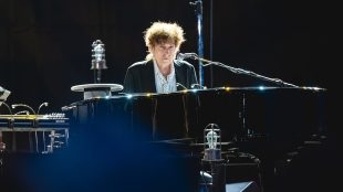 Bob Dylan sat at a piano. Bob Dylan 2025 tour