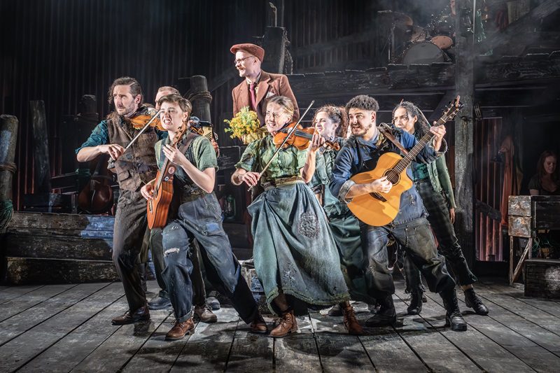 Cast on stage all playing different instruments. Benjamin Button London - cast musicians Silver Magazine www.silvermagazine.co.uk.jpg