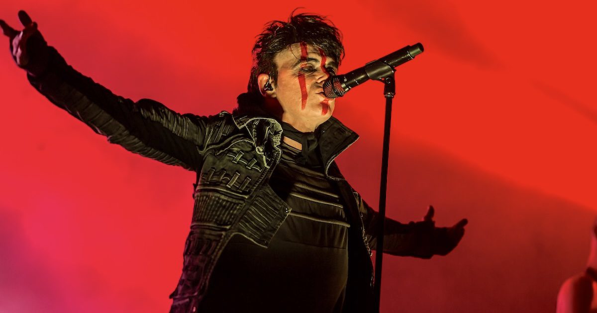 Numan playing live in 2022 with red facepaint against a red-lit concert stage, Gary Numan, Gen Z and beyond: why all ages are tuning in silver magazine, silvermagazine.co.uk