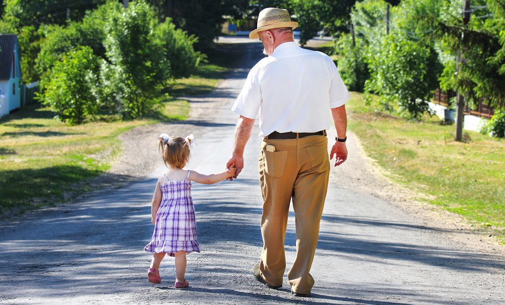 Grandfather walking with granddaughter Silver Magazine www.silvermagazine.co.uk
