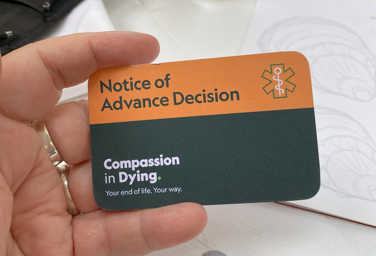 dying with dignity on your own terms and getting a compassion in dying card. A wallet sized card, which is coloured orange and green, with the words "notice of advanced decision" at the top with the Compassion in Dying logo.