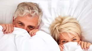 Portrait mature couple in bed for sex, sleep or love in retirement. Shy, intimate woman and man in bed. Mature relationship adventure bed - Silver Magazine www.silvermagazine.co.uk