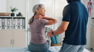 Neck pain, physiotherapy and advice with woman in clinic for healthcare, osteoarthritis or symptoms. Medical, physiotherapy and helping with patient for chiropractor and rehabilitation. Physio tips for neck and shoulder pain