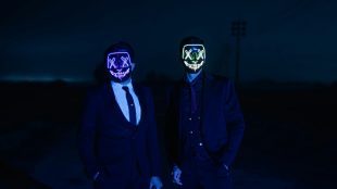 Black background, two men in masks. scammers article on Silver Magazine www.silvermagazine.co.uk