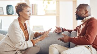 Marriage problem, argument and couple on sofa angry and talking about finance, home mortgage loan or a serious decision. Communication, family law and talking of black people with divorce discussion. Selling house divorce article Silver Magazine www.silvermagazine.co.uk