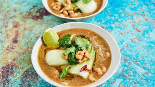 Bowls of Asian looking soup, with noodles, bok choy, shrimps etc