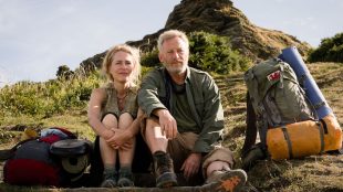 The Salt Path film - Jason Isaacs and Gillian Anderson sat outside. The Salt Path article. Silver Magazine www.silvermagazine.co.uk