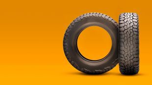 New tyres on an orange background. TMPS valve servicing article Silver Magazine www.silvermagazine.co.uk