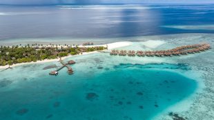 Aerial shot of the resort showing beautiful blue seas, white sands and villas in the sea. Trip to the Maldives Cora Cora review - Silver Magazine www.silvermagazine.co.uk