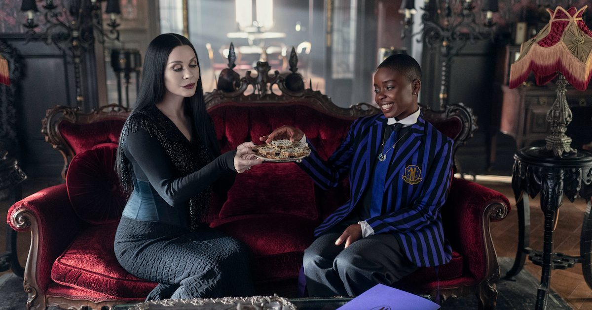 Catherine Zeta Jones as Mortitia and Joy Sunday as Bianca having tea. Wednesday Season 2 article - Silver Magazine www.silvermagazine.co.uk