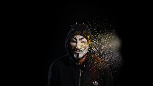 image is black background and person with Anonymous synonymous mask. Why celebrate Guy Fawkes Night article on Silver Magazine www.silvermagazine.co.uk