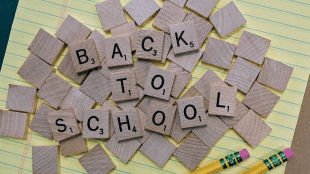 A pile of cut out wooden squares that spell 'back to school'